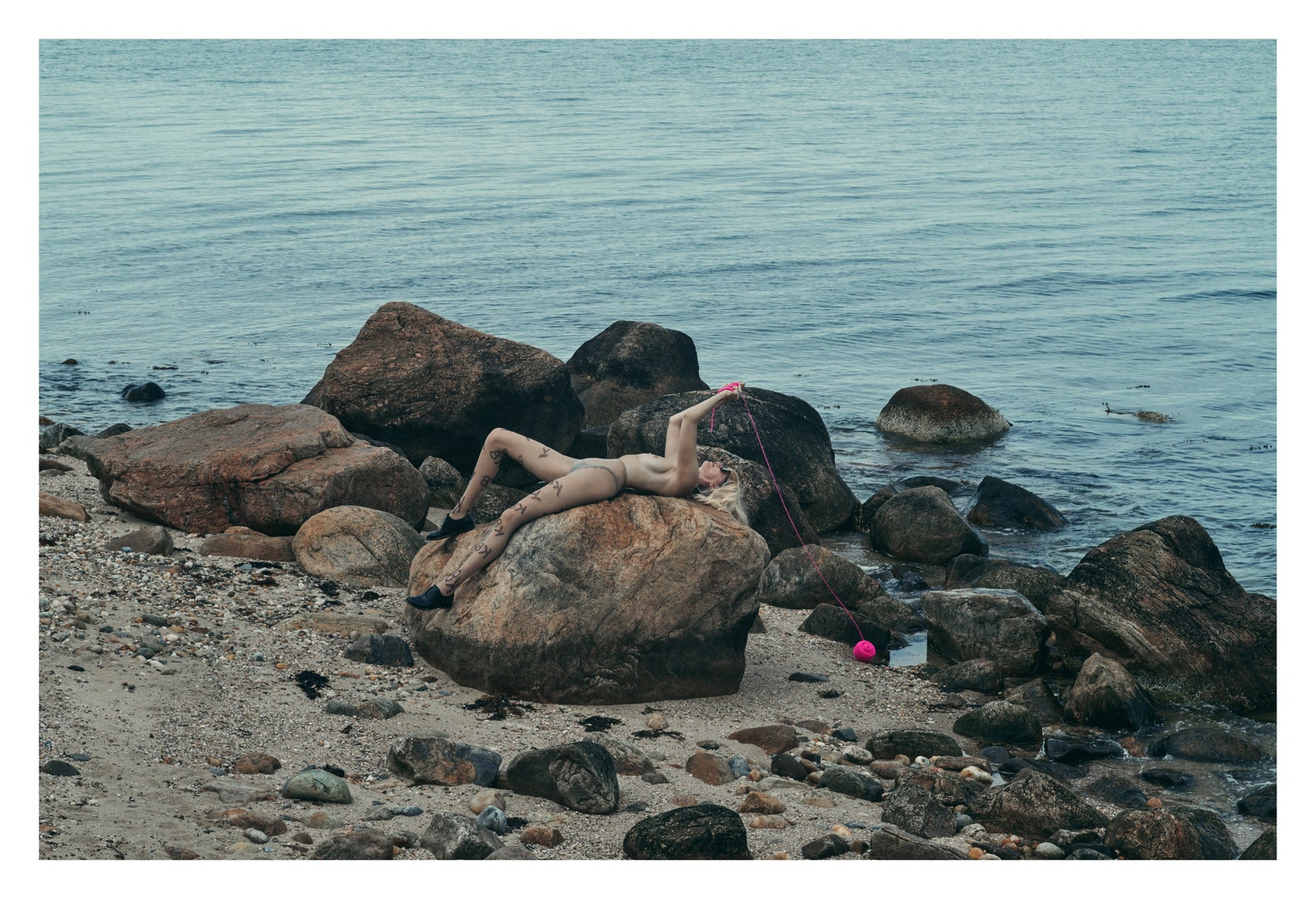 Image may contain Rock Beach Coast Nature Outdoors Sea Shoreline Water Photography Adult Person Face and Head