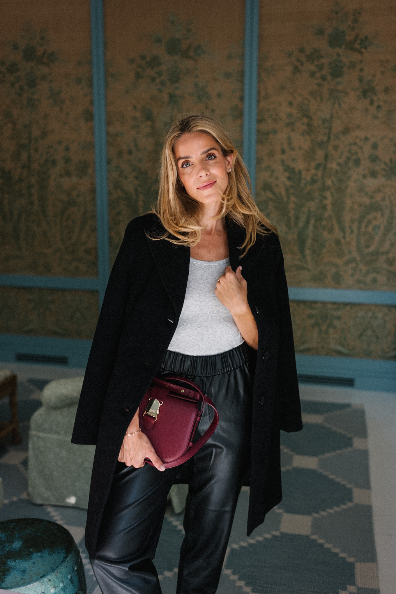 black wool coat black leather pants burgundy handbag