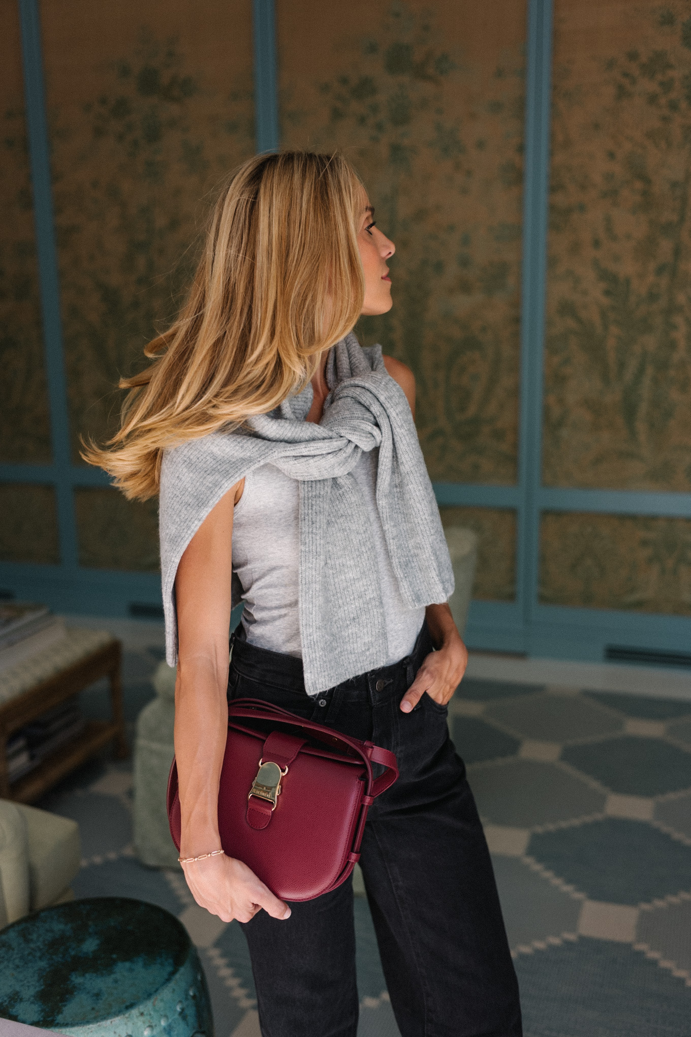 grey sweater black denim jeans burgundy handbag