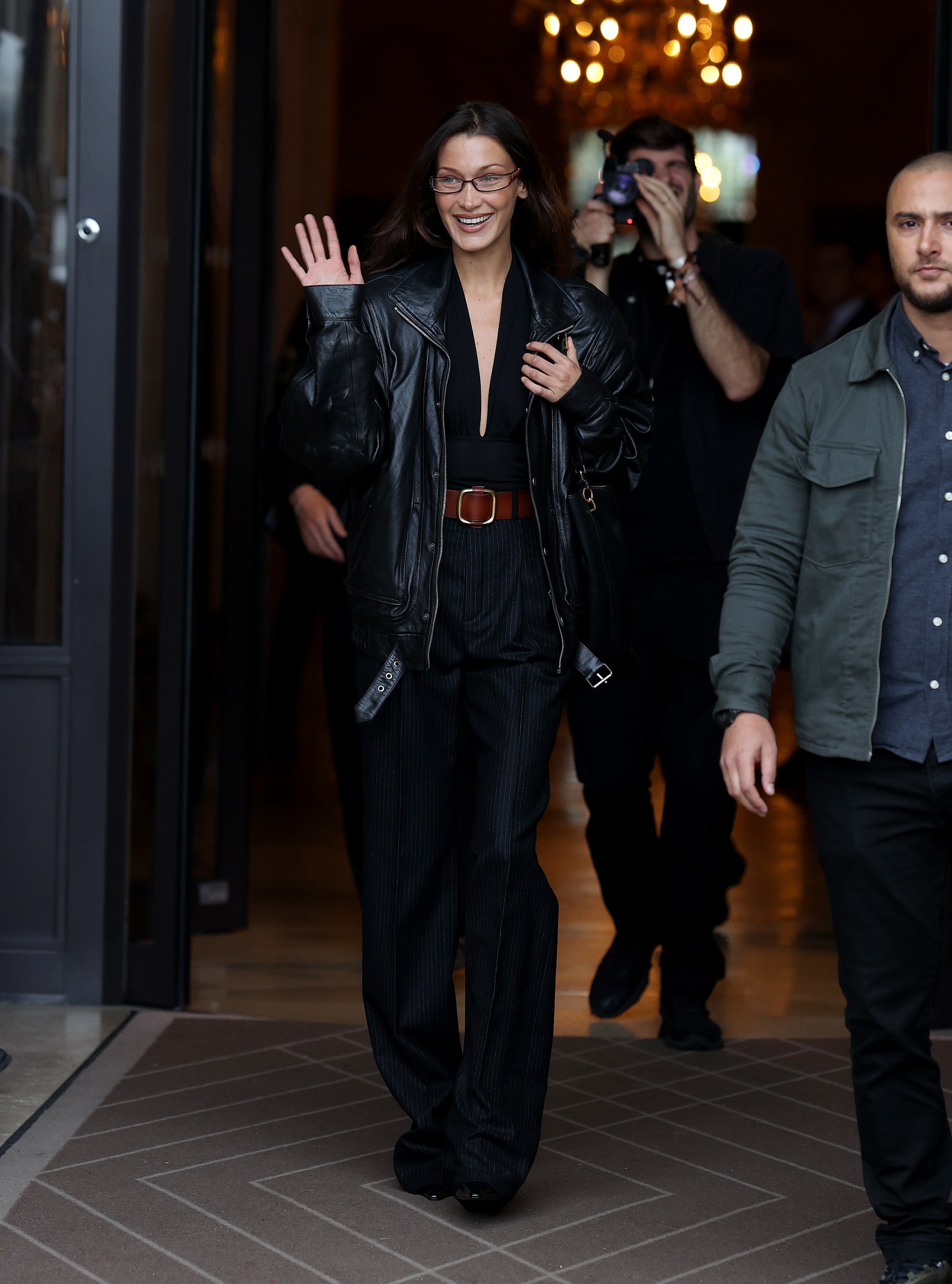 Image may contain Bella Hadid Clothing Coat Jacket Accessories Belt Adult Person Footwear Shoe and Glasses