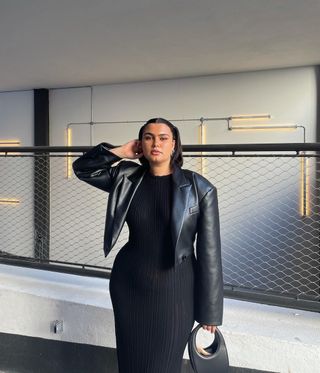 @isabellecoheen wearing a ribbed knit dress and leather jacket