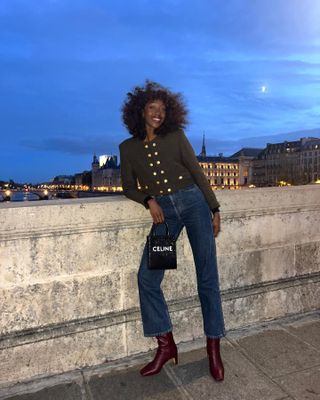 Influencer wears burgundy boots.