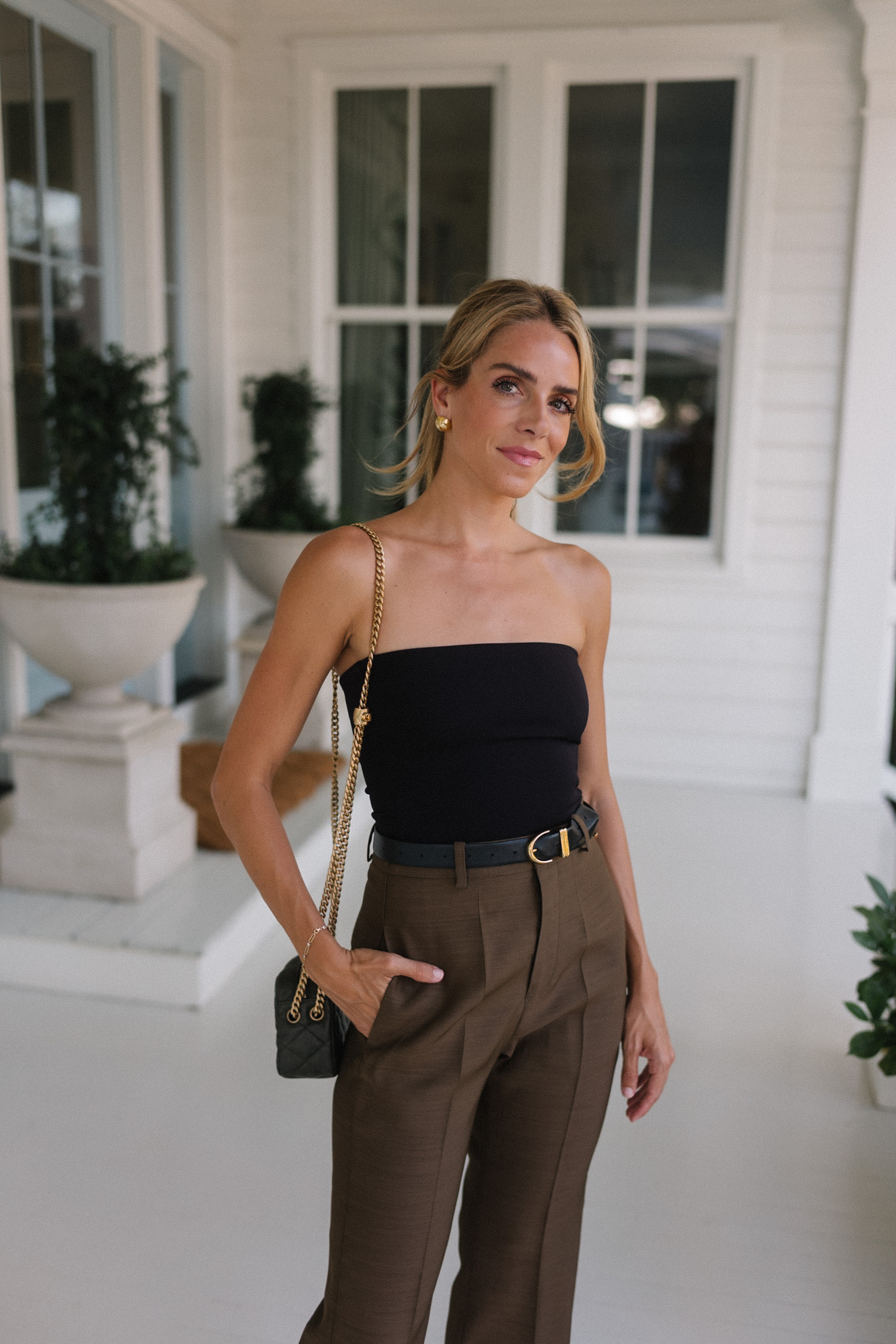 strapless black top brown silk trousers maroon patent leather slingback pumps