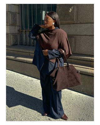 Woman in navy and chocolate brown outfit.