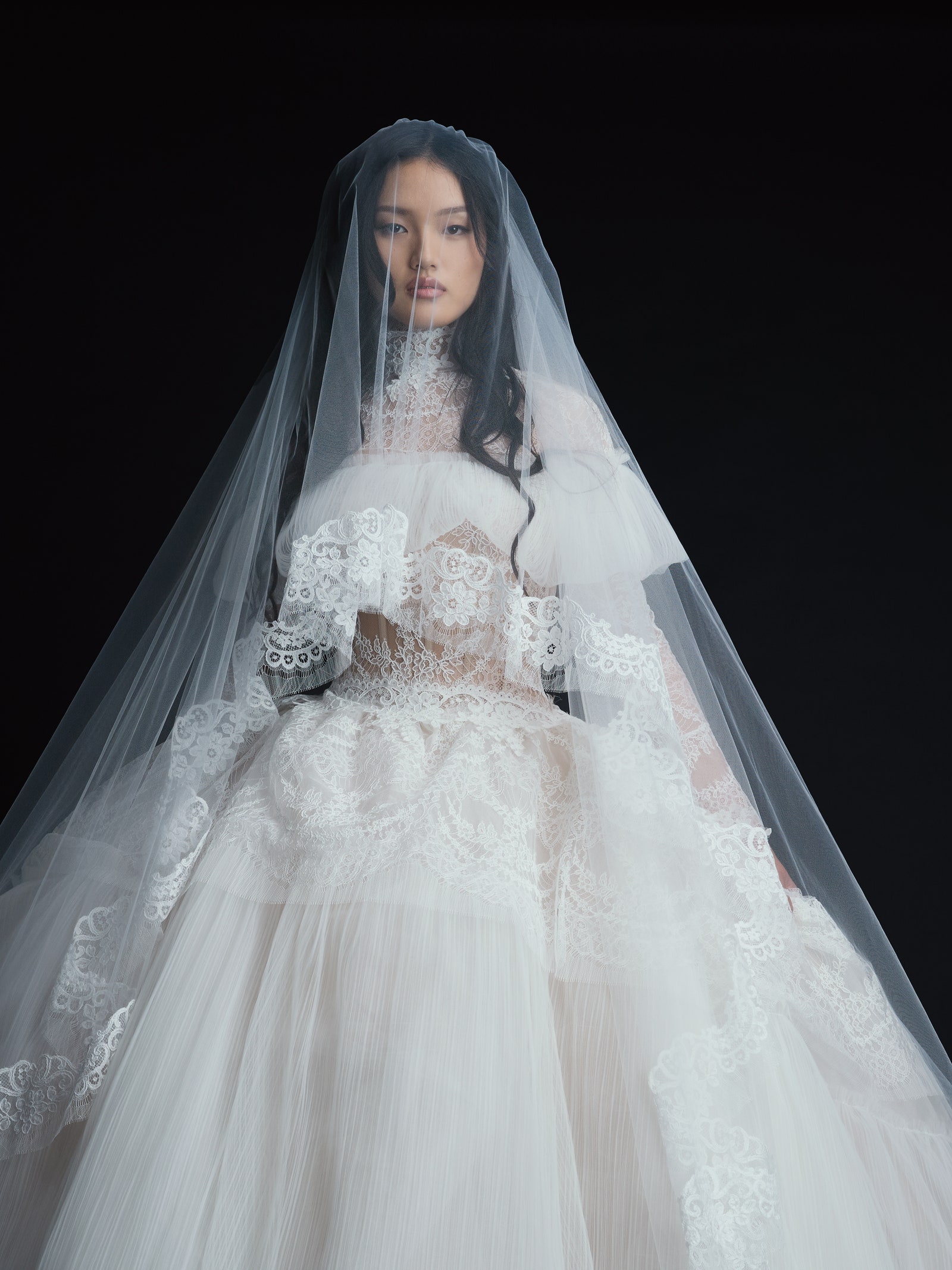 Image may contain Jenny Bae Clothing Dress Fashion Formal Wear Gown Wedding Wedding Gown Veil and Bridal Veil