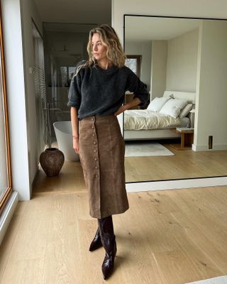 Best Suede Skirts: @anoukyve wears a suede pencil skirt with a grey jumper and leather knee boots