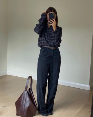 Fashion influencer Marianne Smyth taking a mirror selfie wearing the burgundy color trend with navy.