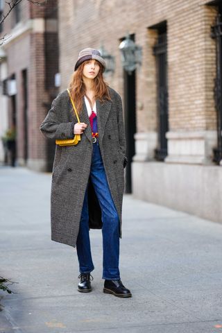 a model wears Dr. Martens boots with jeans