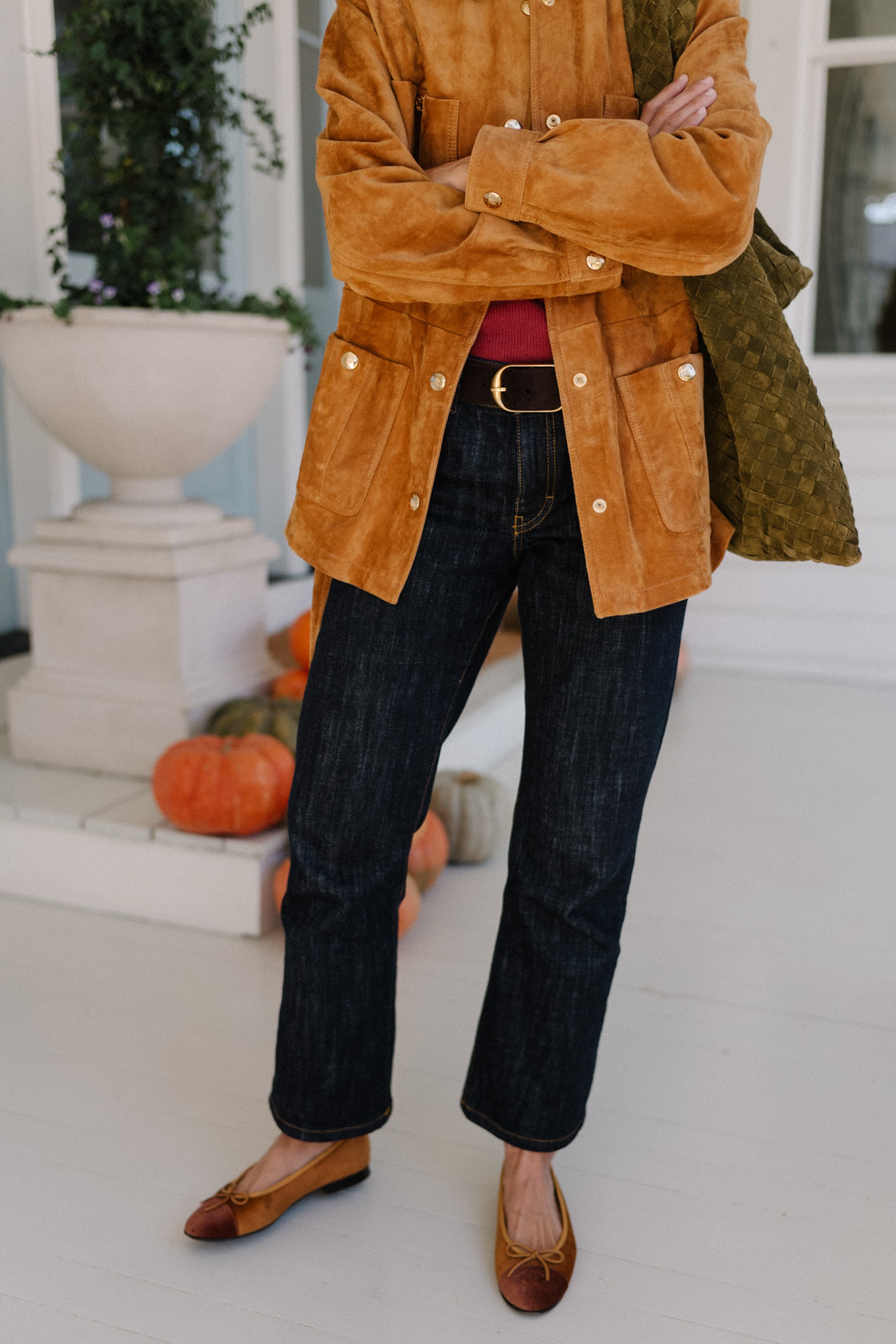 brown suede jacket red sweater dark denim jeans brown flats