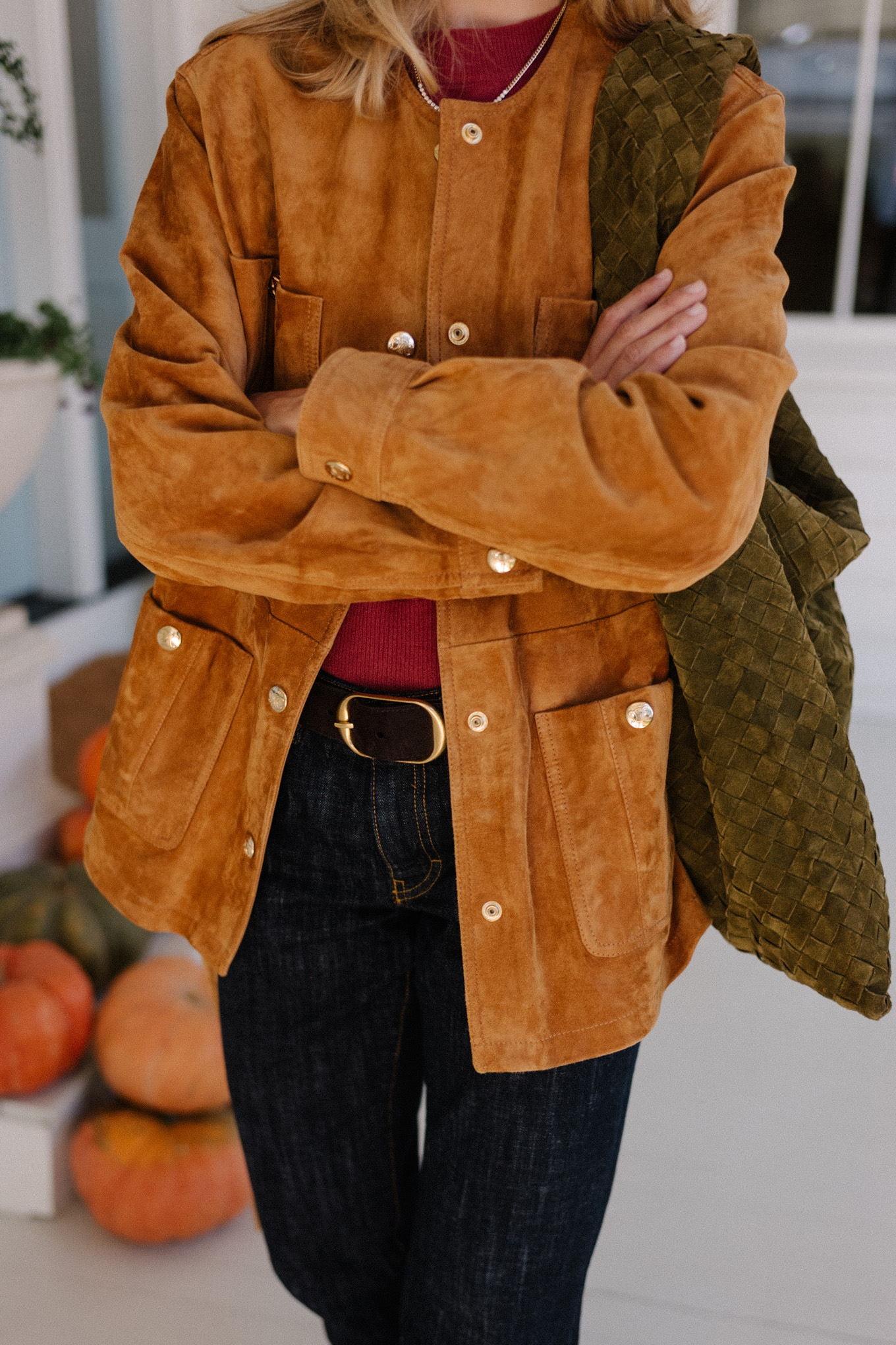 brown suede jacket red sweater dark denim jeans brown flats