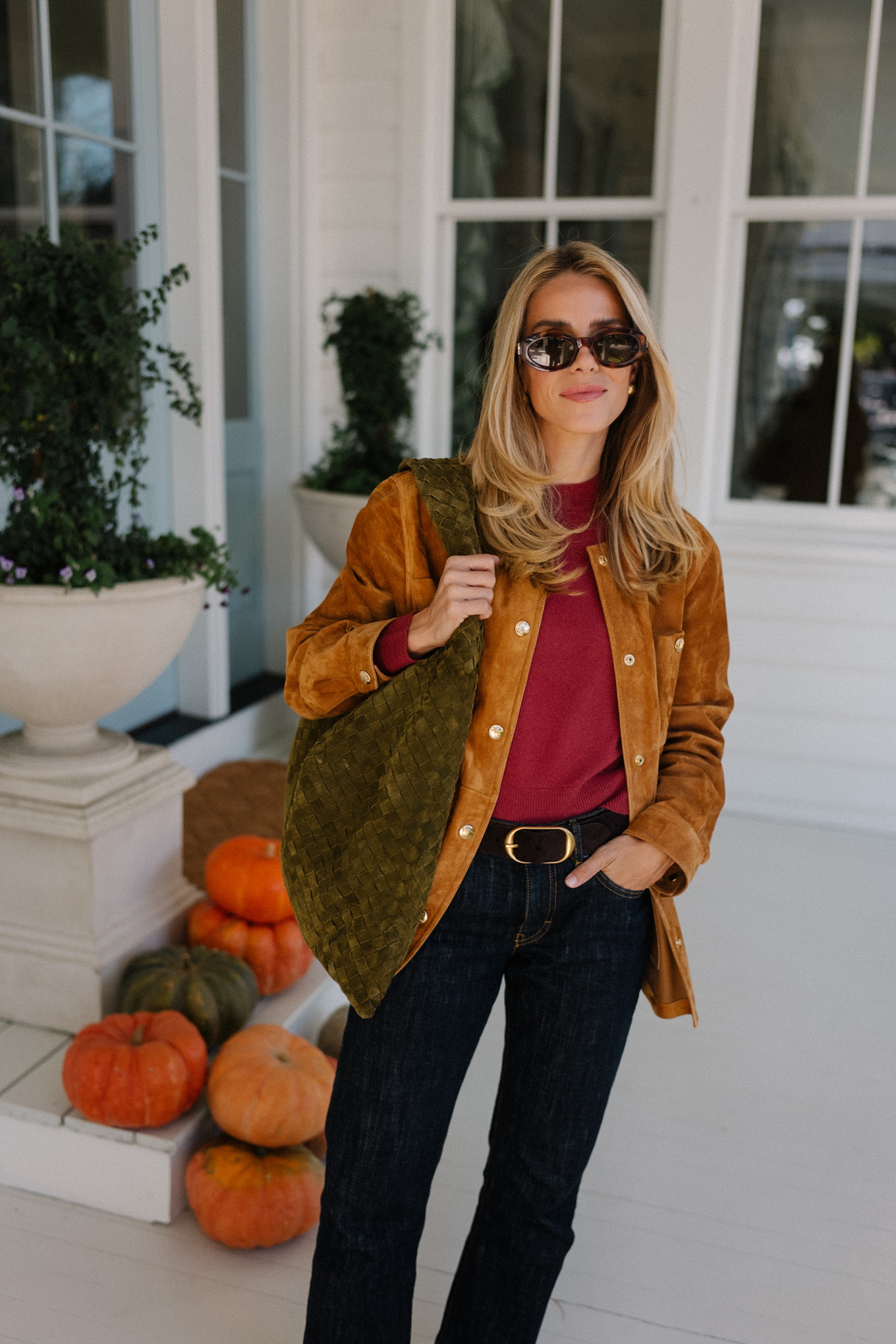 brown suede jacket red sweater dark denim jeans brown flats