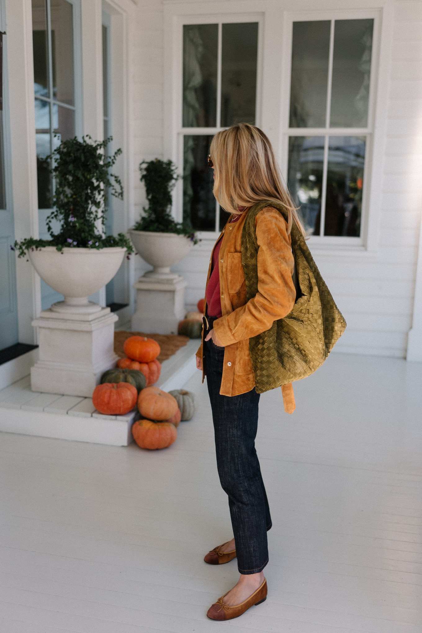 brown suede jacket red sweater dark denim jeans brown flats