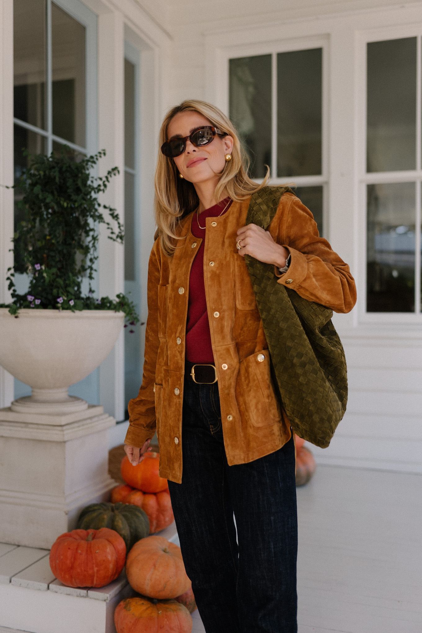 brown suede jacket red sweater dark denim jeans brown flats