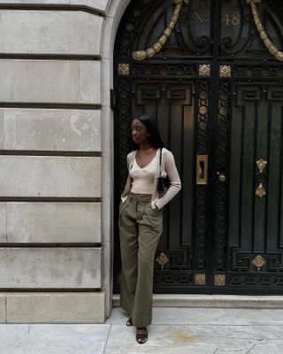 Influencer wears olive green trousers.