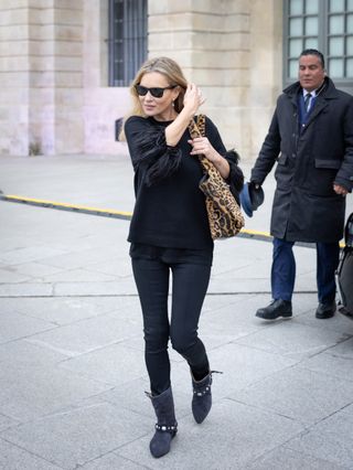 Kate Moss wears a leopard print bag