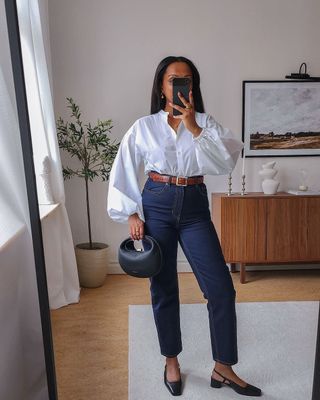 @femmeblk wearing heeled Mary Janes, jeans and shirt