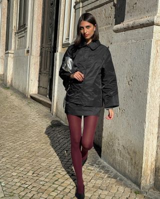 Fashion influencer @salome.mory wearing a chic fall outfit with tights.