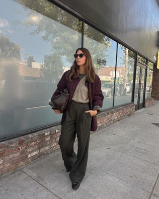 Influencer wearing a barn jacket, trousers, and pointed-toe loafers