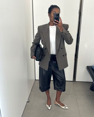 Influencer wearing a blazer, white T-shirt, leather culottes, and Saint Laurent flats