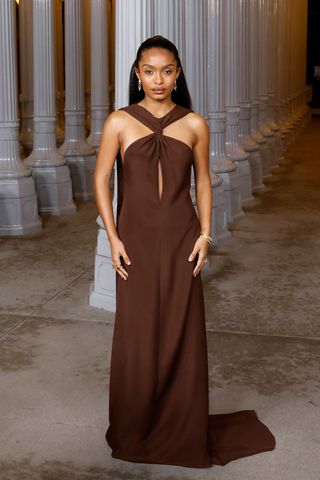 Yara Shahidi wears a chocolate brown party dress.