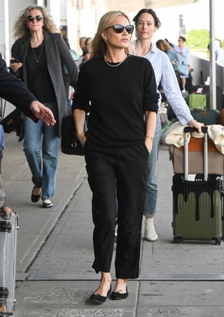 Kate Moss wears ballet flats to the airport.