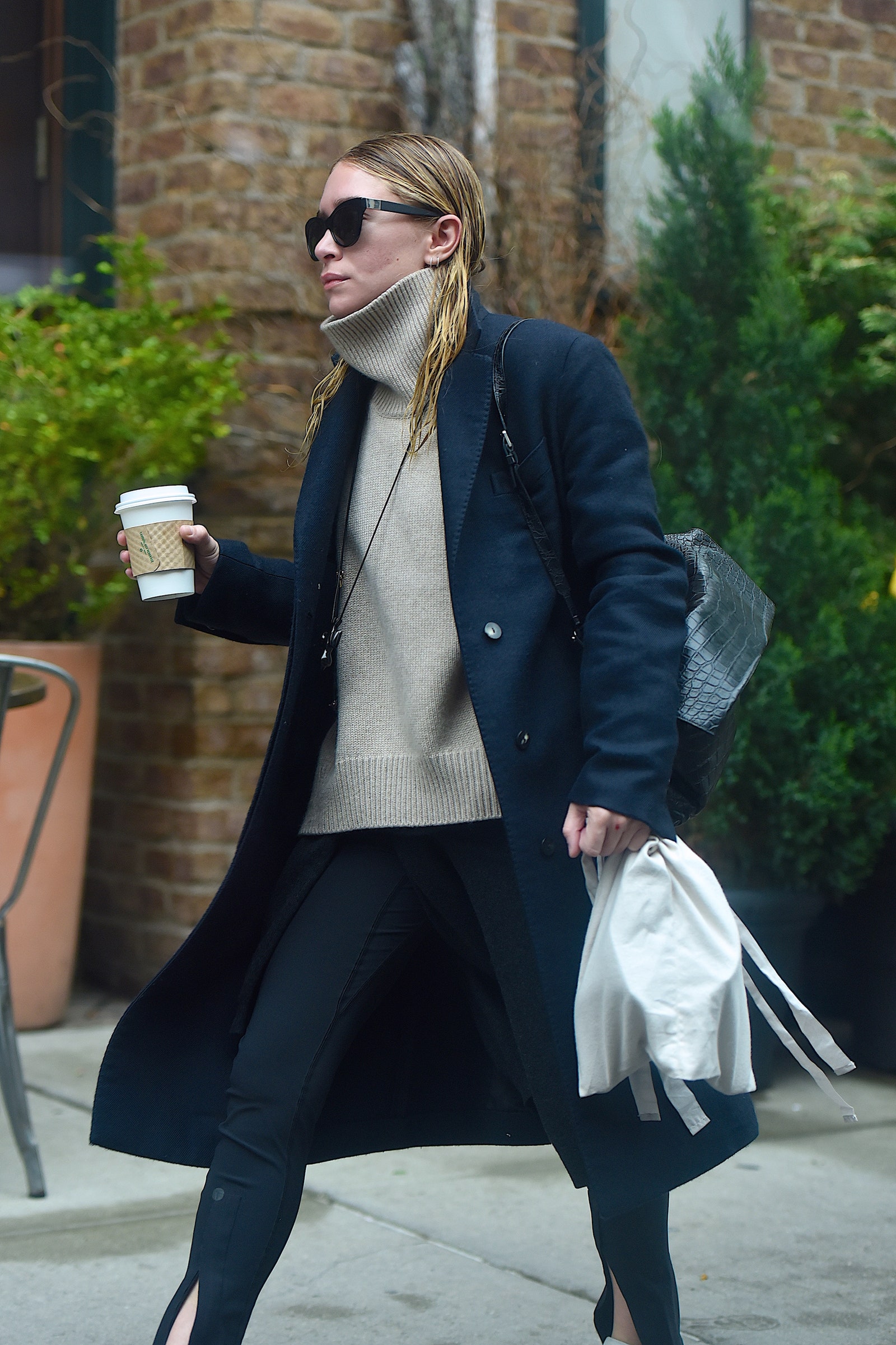 Image may contain MaryKate Olsen Clothing Coat Blazer Jacket Plant Accessories Glasses Bag Handbag and Overcoat