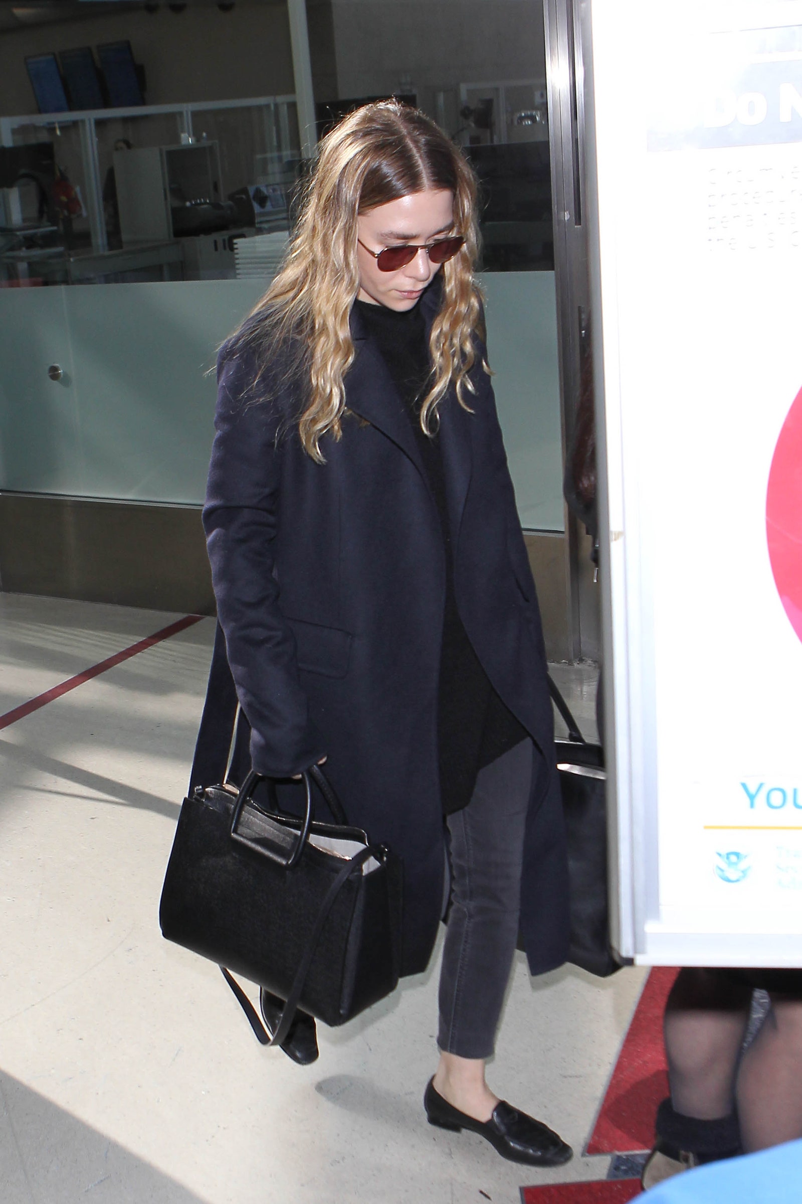 Image may contain Ashley Olsen Clothing Coat Accessories Bag Handbag Glasses Footwear Shoe Adult and Person