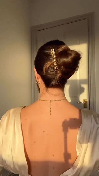 French bun hairstyle with barette