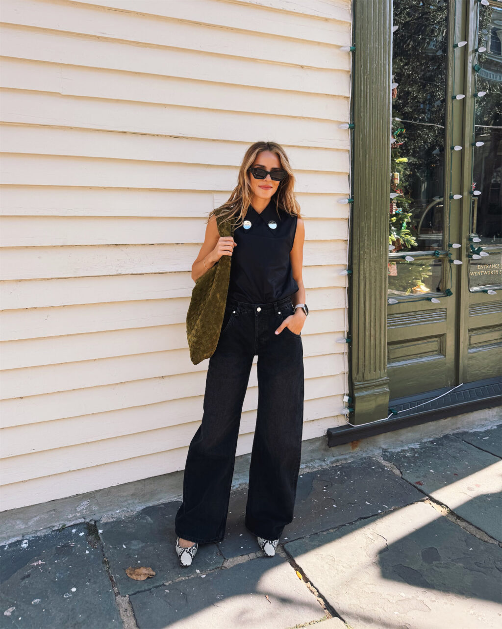 black silk top black baggy jeans snakeskin heels