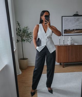 Black trouser outfits: @femmeblk wears a waistcoat with leather trousers