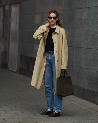 Fashion influencer Anouk Yve wearing an on-trend fall/winter 2024 outfit styled with a chic sweater.