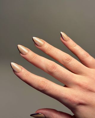 Gold chrome nails with burgundy French tips