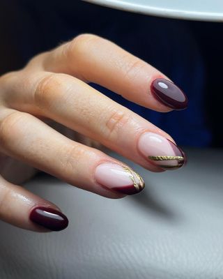 Burgundy and gold French tip nail art accents