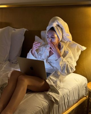 Content creator Emma Leger drinks a martini while wearing a face mask in Paris, France.