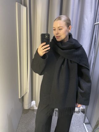 Woman wears black scarf coat