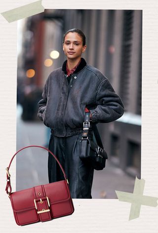 One of the best Michael Kors bags is shown in a street-style photo of a woman wearing a red button-down shirt under a leather bomber jacket with leather pants and a black buckle shoulder bag