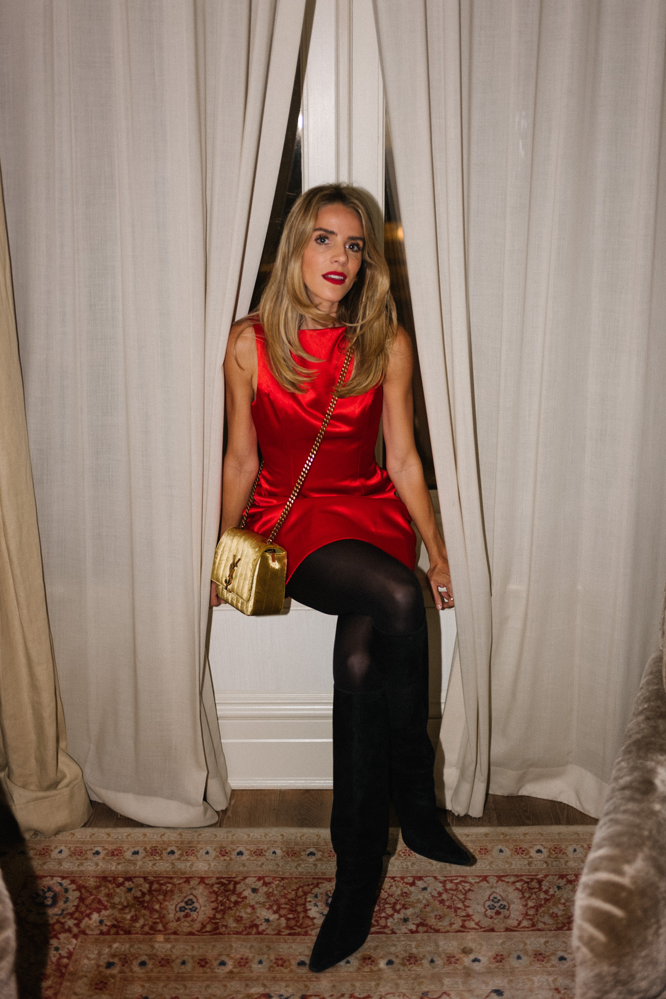 red silk mini dress black tights black boots gold bag