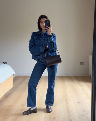 @smythsisters wearing blue denim jeans and jacket