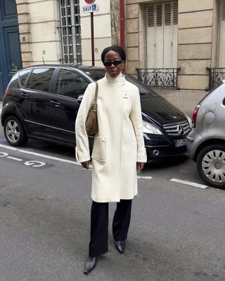 Influencer Sylvie Mus wearing a white coat