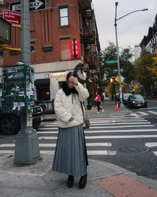 Fashion influencer @eggcanvas in New York City wearing a chic winter outfit styled with a puffer jacket.