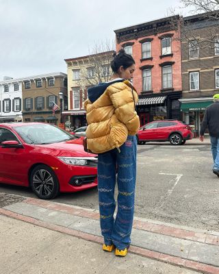 Fashion influencer @anaasaber in New York City wearing a chic winter outfit styled with a puffer jacket.