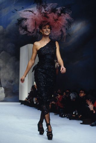 Linda Evangelista wears a black dress on the Chanel runway