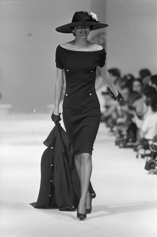 a Chanel model walks the runway wearing an LBD