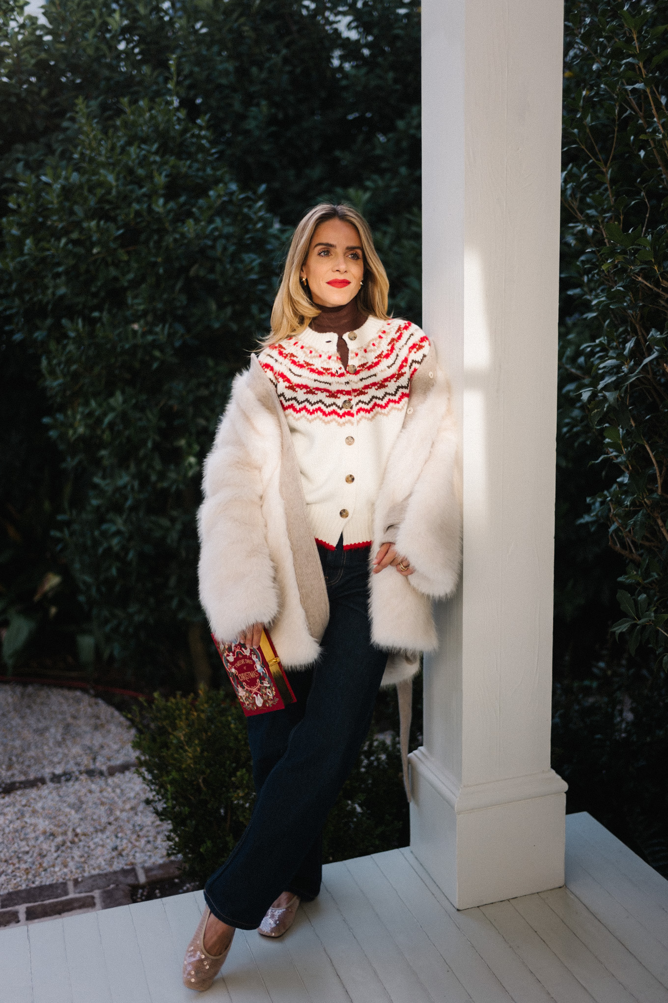 white fur coat white red fair isle cashmere cardigan dark denim red book clutch