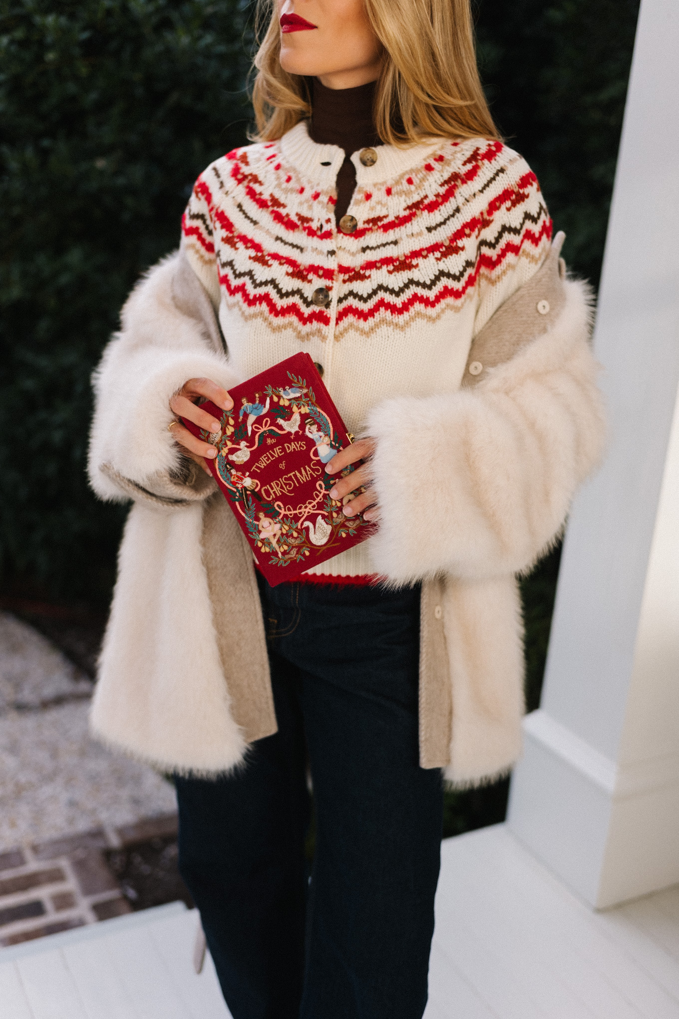 white fur coat white red fair isle cashmere cardigan dark denim red book clutch