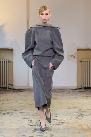 Carven model walking the fall/winter 2024 runway wearing a high roll-neck top