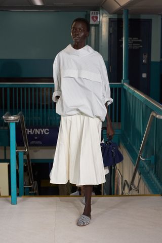 a model walks the Tommy Hilfiger runway wearing the high neckline trend