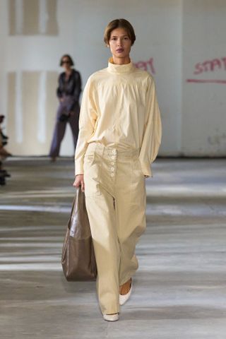 a model walks the Rachel Comey runway wearing the high neckline trend