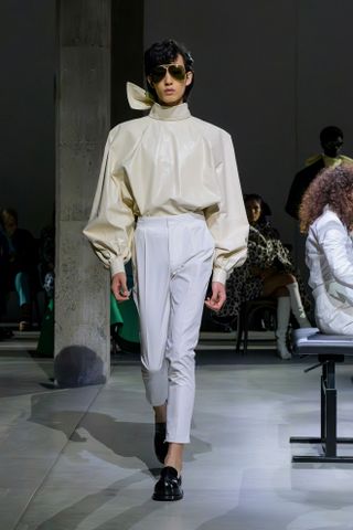 a model walks the Marni runway wearing the high neckline trend