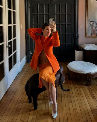 Laura Reilly wearing an orange structured evening jacket from Colleen Allen